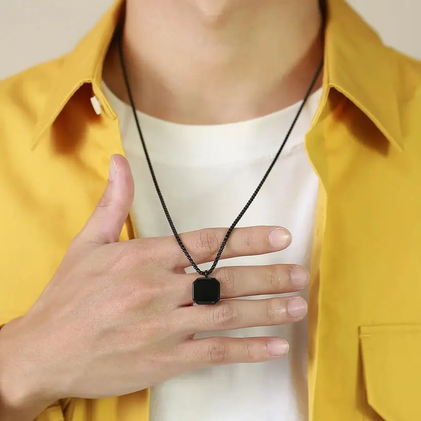 Black geometric pendant necklace on white background