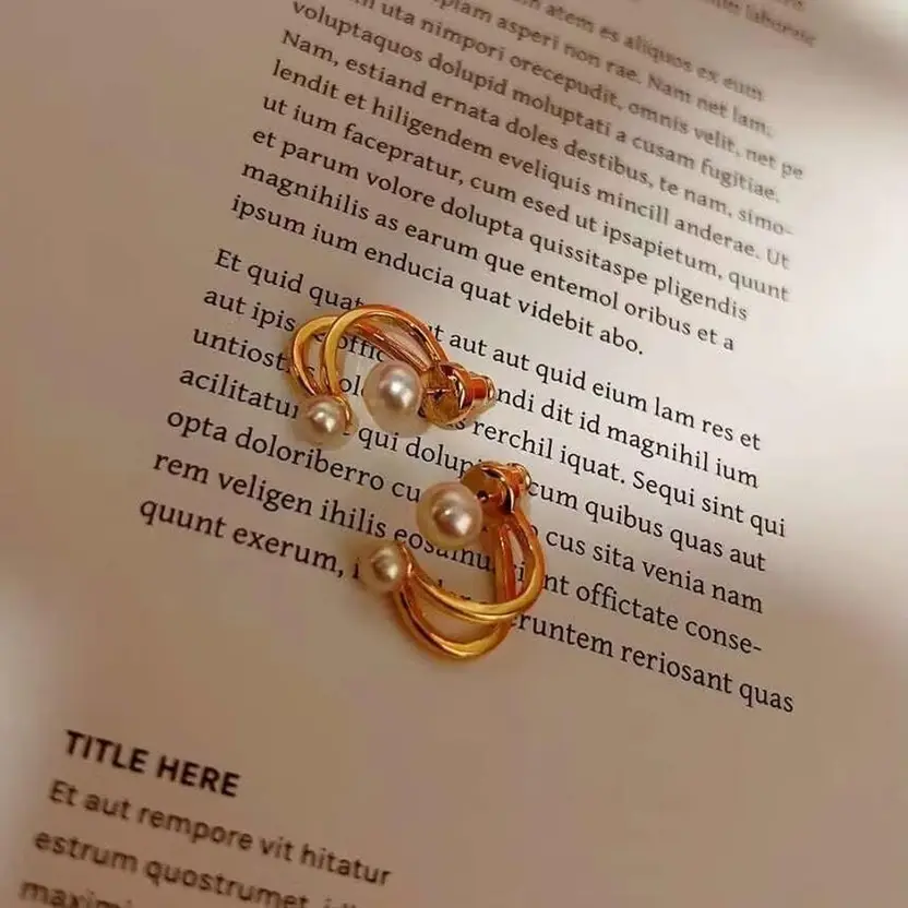 Gold-tone pearl double hoop earrings styled on page
