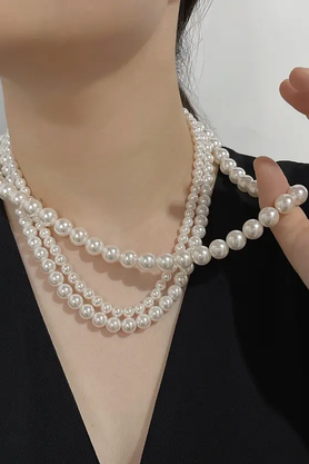 Three-layer white pearl necklace styled on a mannequin
