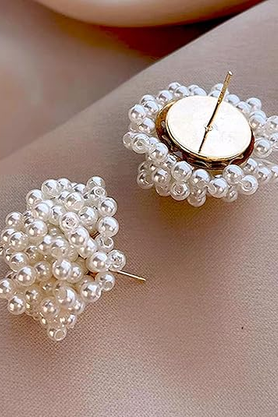 White pearl beaded stud earrings on ear
