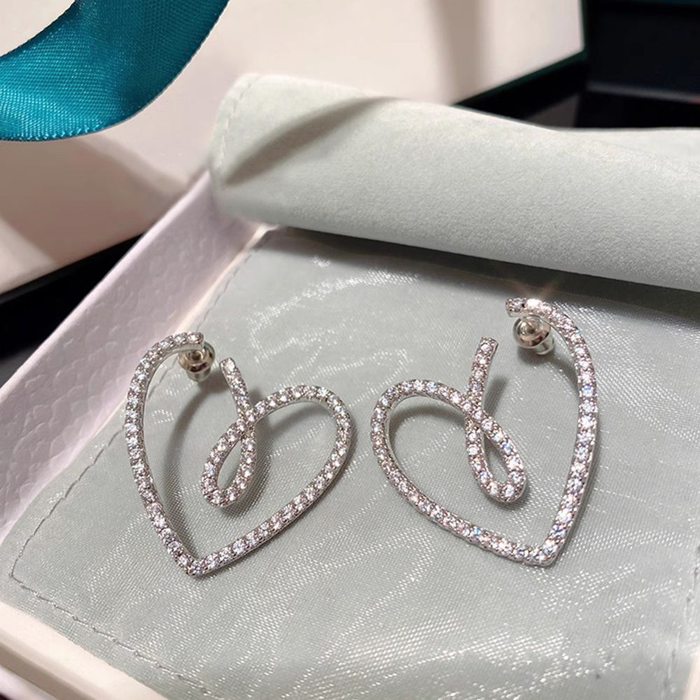 Crystal-pave heart earrings in red jewellery box