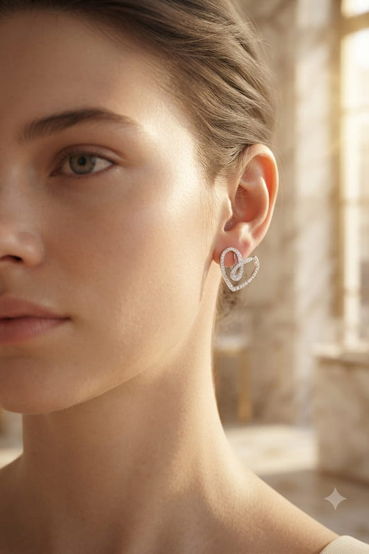 Crystal-pave heart earrings worn on ear