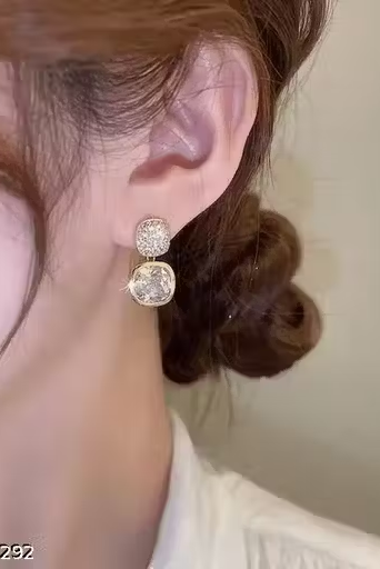 Crystal cushion drop earrings worn on ear