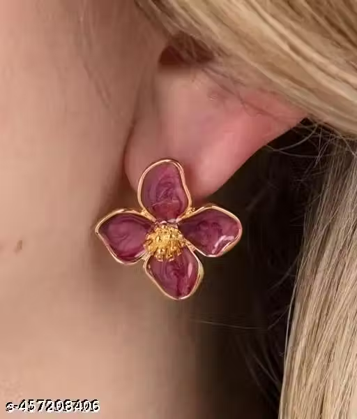 Red floral stud earrings worn on ear