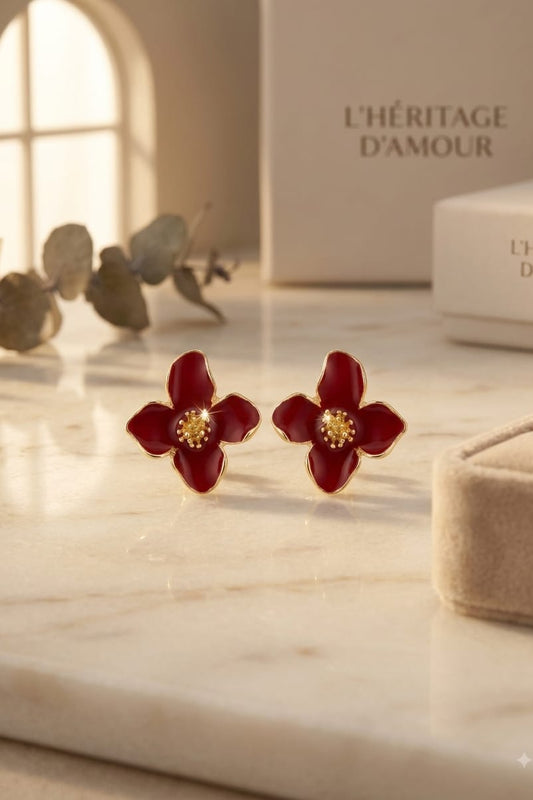 Pair of red flower stud earrings on jewellery card