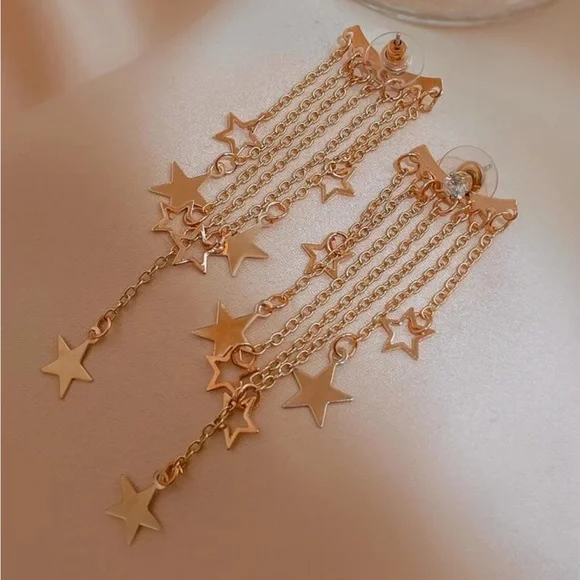 Gold-tone star chain earrings on display