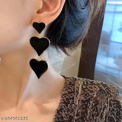 Black heart three-tier drop earrings close-up on ear