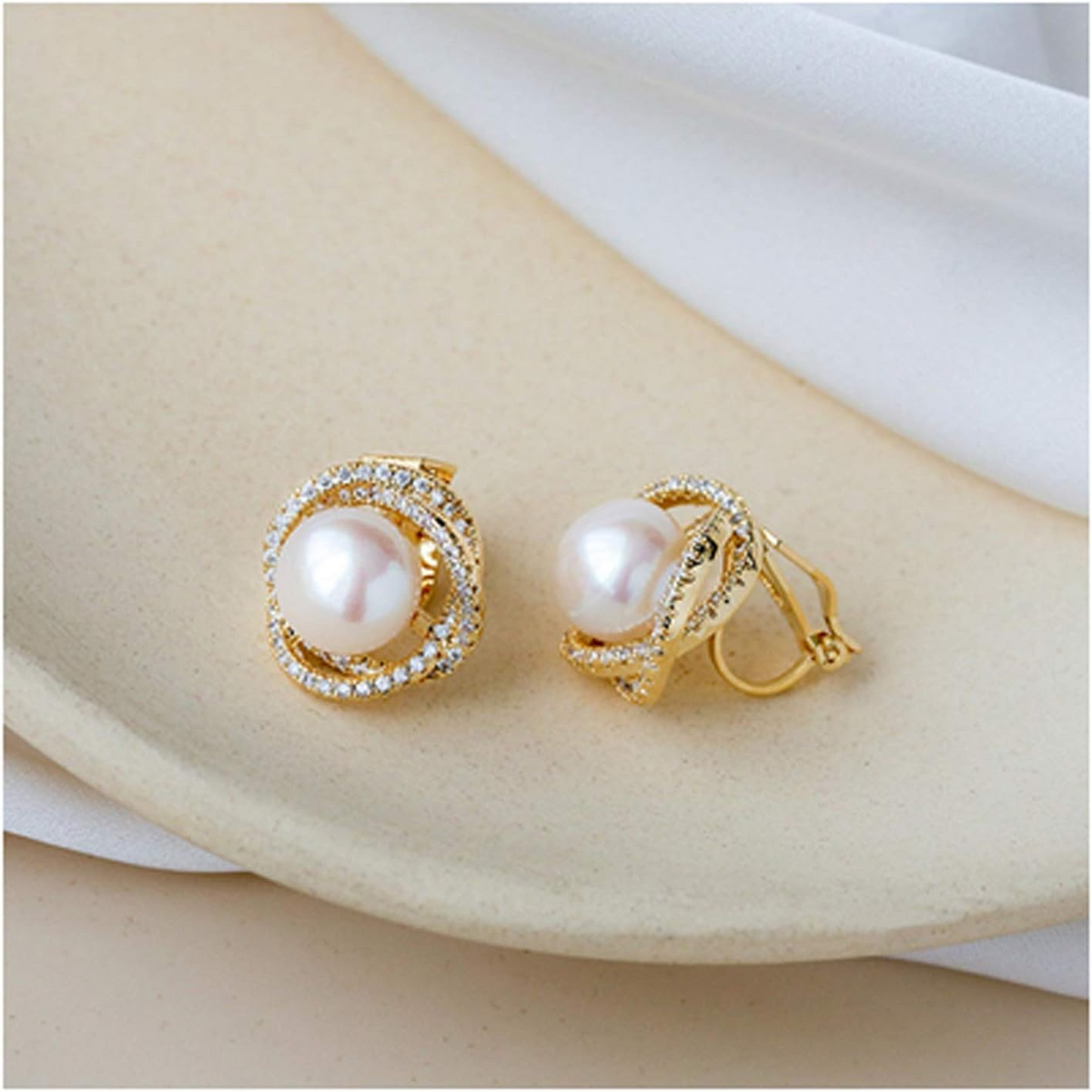 Gold-tone pearl crystal stud earrings on display