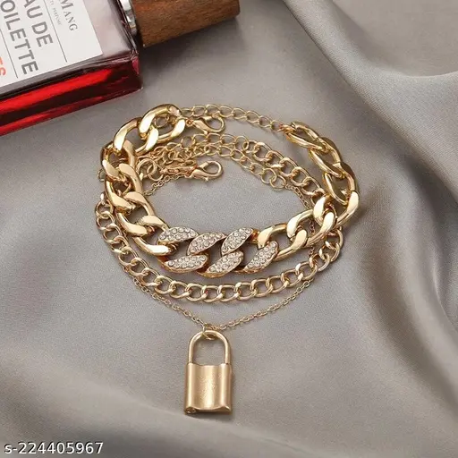 Gold-tone layered chain bracelet product detail with crystal leaf links