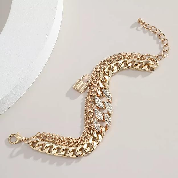 Gold-tone layered chain bracelet close-up with padlock charm