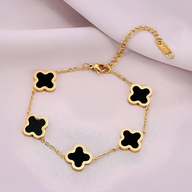 Black clover charm bracelet on pink background