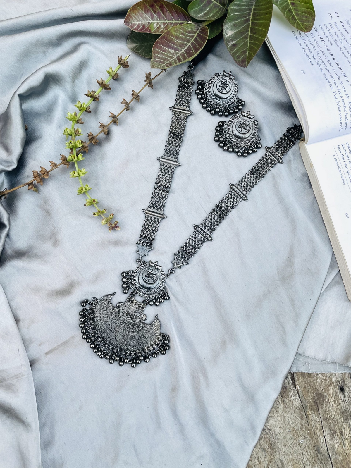Full view of oxidised silver-tone crescent necklace set with earrings