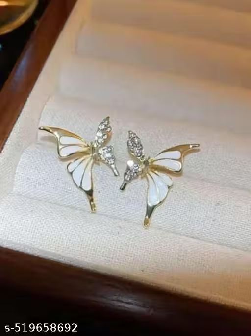 Gold-tone butterfly earrings displayed on fabric