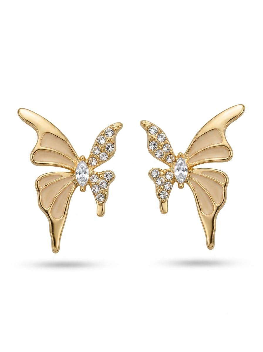 Gold-tone butterfly earrings held in hand