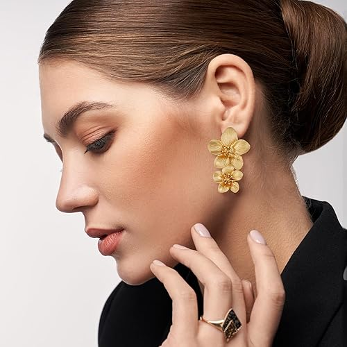 Gold-tone double flower earrings worn on model