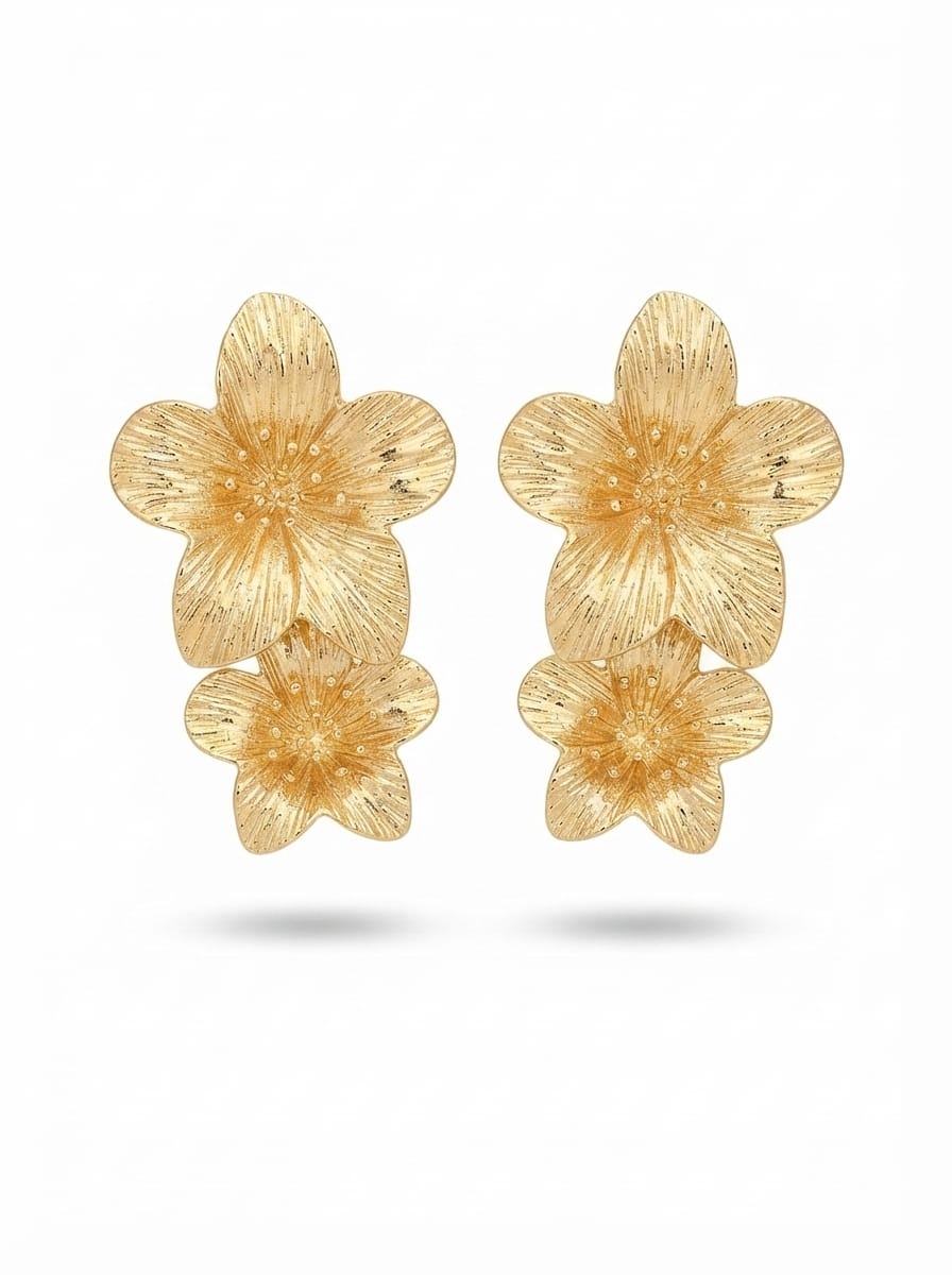 Gold-tone floral earrings on model side profile